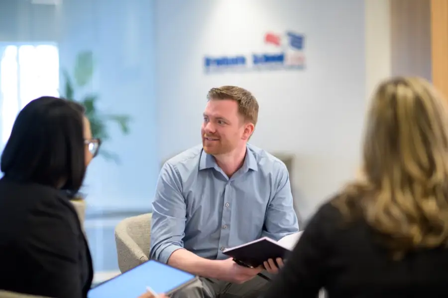 A Graduate School USA advisor working through a training plan with two federal employees