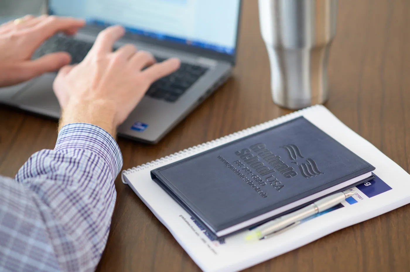 A federal employee working through a Graduate School USA course on a laptop